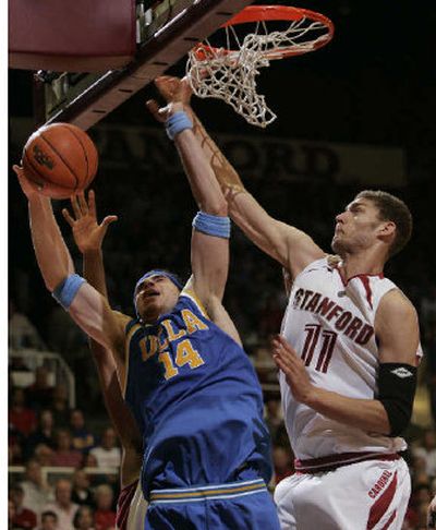 
Stanford forward Brook Lopez (11) bats the ball from UCLA center Lorenzo Mata (14). 
 (Associated Press / The Spokesman-Review)