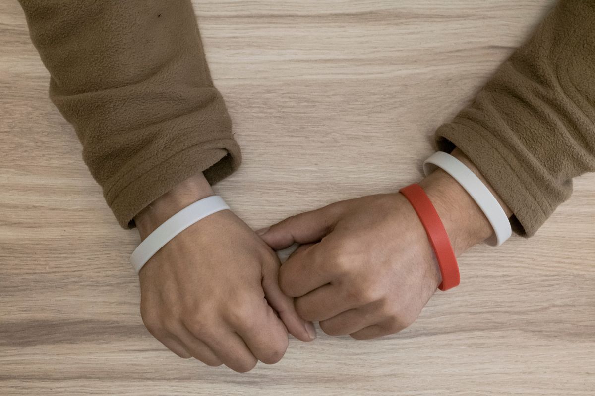 Bracelets showing the HIV and hepatitis C status of a captured Wagner fighter at a prison in Dnipro, April 6, 2023. For the estimated 20 percent of Russian prison recruits who are HIV positive, serving on the front lines in Ukraine for the Wagner mercenary group seemed less risky than staying in prison, where they were denied effective treatments. (Mauricio Lima/The New York Times)  (MAURICIO LIMA)