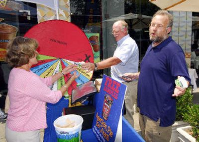 
Ben Cohen, center, and Jerry Greenfield, right, founders of Ben & Jerry Homemade Inc., serve ice cream to Washington residents on Tuesday to kick off a federal budgets priority campaign. 
 (Associated Press / The Spokesman-Review)