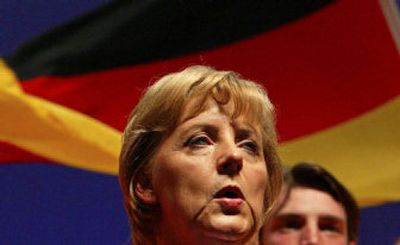 
Conservative challenger Angela Merkel, leader of Germany's Christian Democratic Union, sings the national anthem after giving a speech during the final election campaign rally Friday in Berlin0. 
 (Associated Press / The Spokesman-Review)