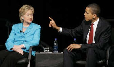 
Sen. Hillary Rodham Clinton, D-N.Y.,  listens as Sen Barack Obama, D-Ill., makes a point at a forum  in Chicago on Saturday. Associated Press
 (Associated Press / The Spokesman-Review)