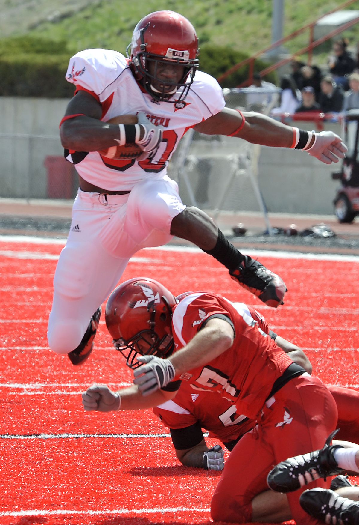 Eastern Washington University's Darriell Beaumonte hurdles linebacker Bobby Gentry in the second quarter near the goal line during the Eagles' 2011 Red-White football game at Roos Field in Cheney, Wash. (Dan Pelle / The Spokesman-Review)