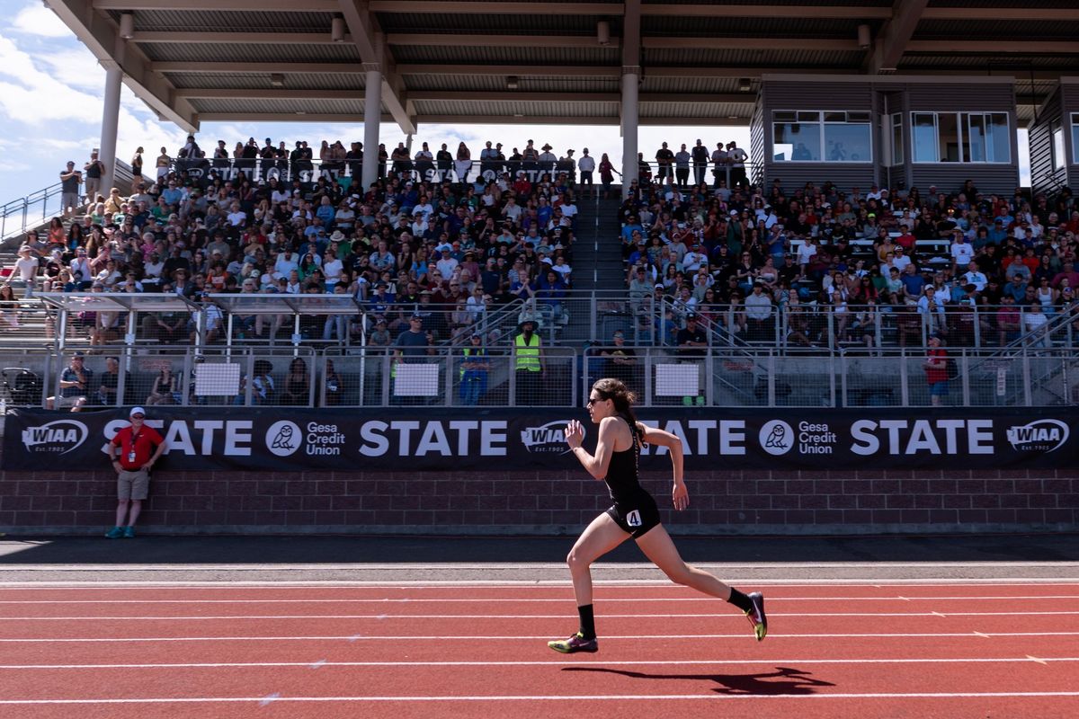 East Valley’s Veronica Garcia, the defending champion, runs in front of a packed stadium Friday as she completes the girls State 2A 400-meter preliminaries at Mount Tahoma High School in Tacoma. Garcia had the third-fastest time in prelims.  (Joshua Hart/For The Spokesman-Review)