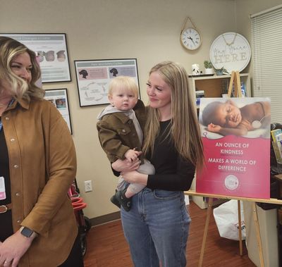Rikki Hector holds 15-month-old son Coen Rogers during the launch of Deaconess Hospital’s milk bank in February. (Amanda Sullender / The Spokesman-Review)
