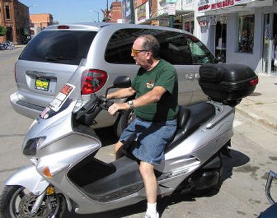 
Silversmith Fred Hathaway of Dover, Del., parks his scooter in Sturgis, S.D., during its recent annual motorcycle rally. 
 (Associated Press / The Spokesman-Review)