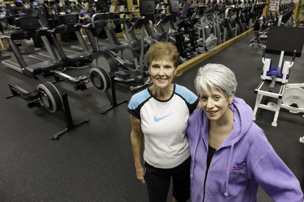 Esther Robinson, 93, left, and DeEtte Sauer, 69, pose at an athletic club in Houston. Sauer is a medal-winning senior swimmer and Robinson likes to hit the gym for the weights, but also enjoys dancing.  (Associated Press)