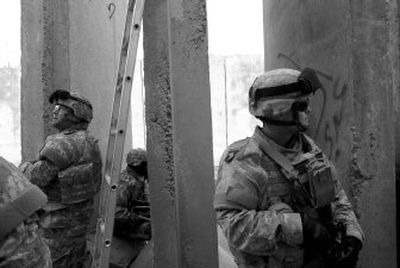 
U.S. soldiers from the 20th Engineer Battalion stand guard  at a joint security station Sunday  in Baghdad. The Pentagon is trying to rely less on a policy used in the past several years that holds some service members past their retirement dates or enlistment terms. 
 (Associated Press / The Spokesman-Review)