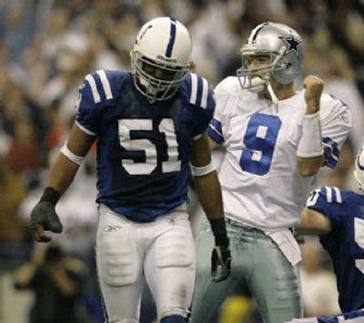 
Cowboys quarterback Tony Romo (9) pumps his fist after Marion Barber scored the go ahead touchdown. 
 (Associated Press / The Spokesman-Review)