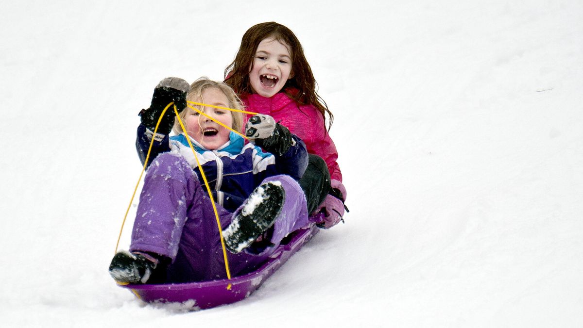 Natalie Nelson,6, front and Texas Falquist, 7, sled at Cherry Hill Park in Coeur d'Alene on Friday, Dec. 29, 2017. (Kathy Plonka / The Spokesman-Review)