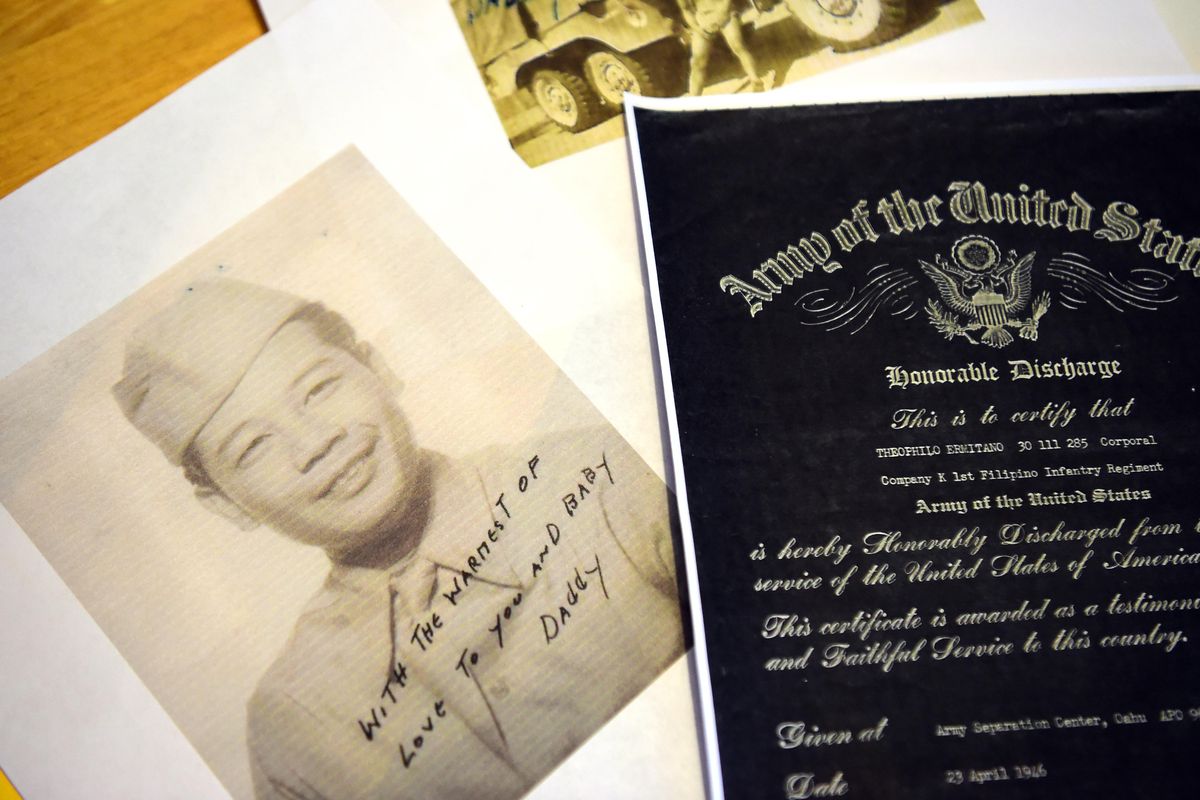 Spokane resident Keith Ermitano, the son of a Filipino soldier who served in the U.S. Army in World War II, displays some memorabilia Wednesday, May 2, 2018, at his Spokane home after learning that his Hawaii-raised father, Theophilo Ermitano, will posthumously receive an special honor for being part of a segregated all-Filipino regiment. (Jesse Tinsley / The Spokesman-Review)