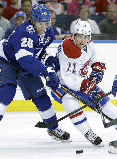 Montreal right wing Brendan Gallagher moves the puck around Lightning defenseman Matt Carle during the first period. (Associated Press)