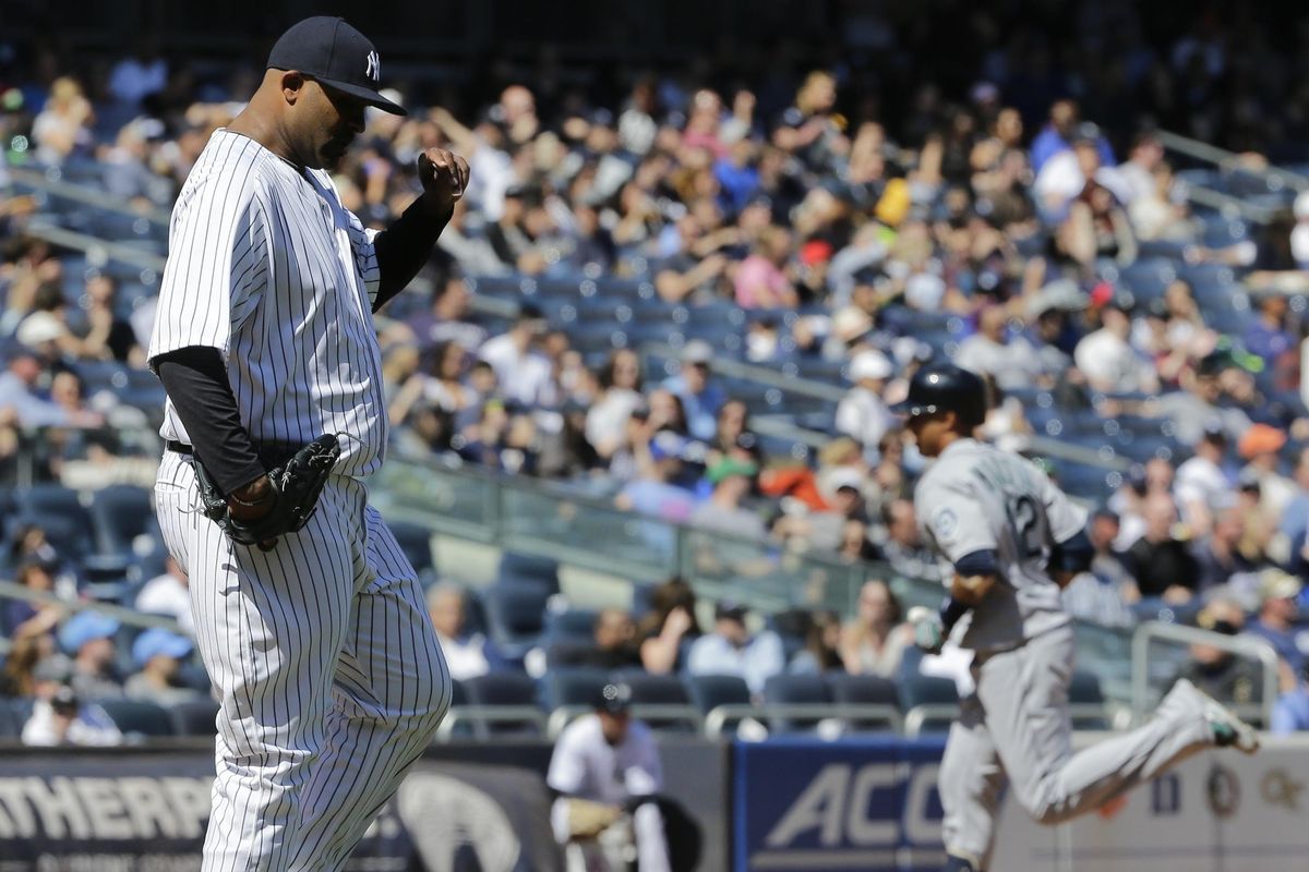 Yankees starting pitcher CC Sabathia reacts as Mariners’ Leonys Martin runs the bases after hitting a home run during the fifth inning. (Frank Franklin II / Associated Press)