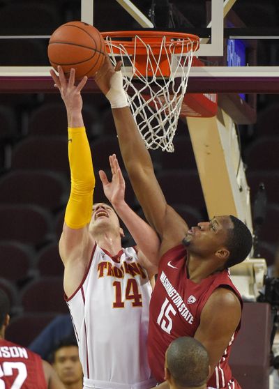 WSU’s Junior Longrus blocks shot by Strahinja Gavrilovic. (Associated Press)