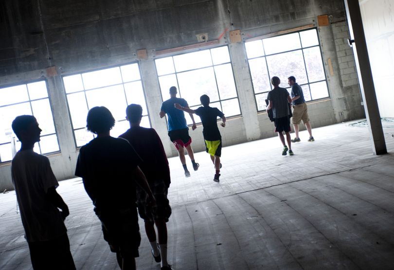 Spokane Valley Tech students run though the large room that used to be a Rite-Aid during a sports medicine class taught by Keith Eggleston on Wednesday. Eggleston was teaching the students how to analyze body movements and make corrections for injury prevention and efficiency. (Tyler Tjomsland)