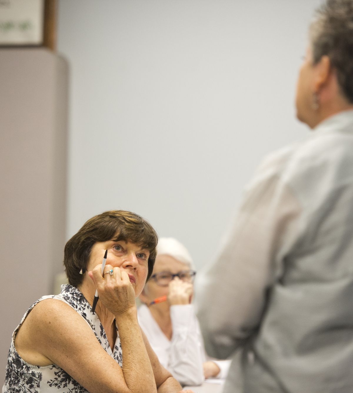 Linda King, left, a senior outreach volunteer, listens to Yolanda Lovato, director of planning and resources for Aging and Long Term Care of Eastern Washington, at a July 15 meeting. The ALTCEW offered an overview of funding for the agency’s next four years. (Jesse Tinsley)