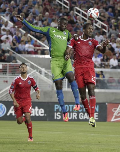 Earthquakes midfielder Atiba Harris, right, goes up for a header next to Sounders’ Jalil Anibaba. (Associated Press)