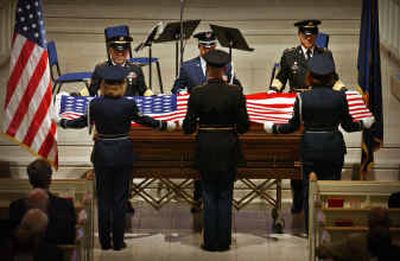 
Members of an honor guard fold a U.S. flag that was draped on the casket of former Idaho Gov. Robert Smylie at the conclusion of a funeral at Cathedral of the Rockies in Boise on Wednesday.
 (Associated Press / The Spokesman-Review)