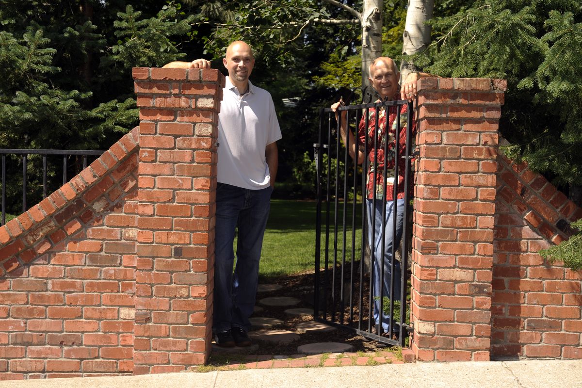 jesset@spokesman.com Gib Kocherhans, right, and his son Gib K. Kocherhans stand  at the gate to the garden at their northside home. The Kocherhans family has pitched in to turn the plain rancher into a varied garden spot that will be on the Associated Garden Clubs tour. (Jesse Tinsley / The Spokesman-Review)