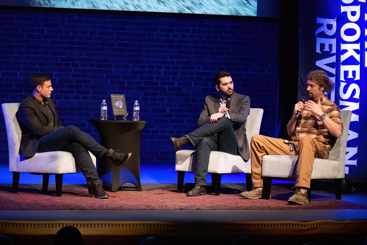 Spokesman-Review journalist and author Eli Francovich, left, has a conversation with photojournalist Tyler Tjomsland, center, and range rider Daniel Curry about Francovich’s new book, “The Return of Wolves,” which investigates how the West might mend this divide while keeping wolf populations thriving, during a Northwest Passages event Thursday at the Bing Crosby Theater. Curry is a figure in the book.  (Colin Mulvany/The Spokesman-Review)