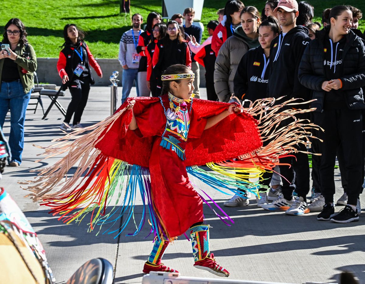 Athletes from Spain, right, watch Simmsci Sonneck, 8, of the Kalispel Tribe, perform a traditional dance during Cultural Day on Sunday in Riverfront Park’s Pavilion. Some 400 athletes from 40 countries are participating in the 2023 Badminton World Junior Championships. The championships run through Oct. 8 at the Podium.  (DAN PELLE/THE SPOKESMAN-REVIEW)
