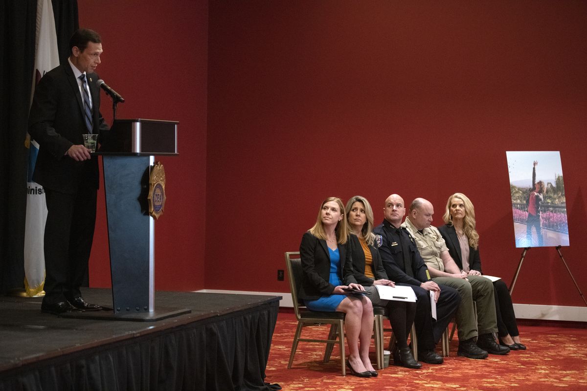 Drug Enforcement Administration Special Agent In Charge Frank A. Tarentino, left, from the Seattle office of the DEA, speaks Tuesday, March 29, 2022, while other seated dignitaries, from left, U.S. Attorney Vanessa Waldref, Spokane Mayor Nadine Woodward, Spokane police Chief Craig Meidl, Spokane County Sheriff Ozzie Knezovich and Marsha Malsam of the Spokane Alliance for Fentanyl Education listen at a news conference about the growing problem with the drug Fentanyl held at the Davenport Grand. At far right is a photo of Rayce Rudeen, a Freeman High School graduate who overdosed on synthetic opioids in 2016. His family has started a foundation in his name to do education about fentanyl.  (Jesse Tinsley/THE SPOKESMAN-REVIEW)