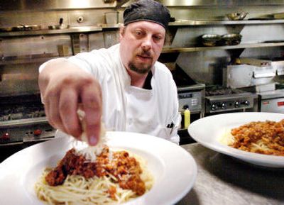 
Luigi's Restaurant sous chef Dave Bible prepares donated dinners before they are served Saturday night to raise funds to help the families of burn victims Brian Ashmore and Alex Brown. 
 (Joe Barrentine / The Spokesman-Review)