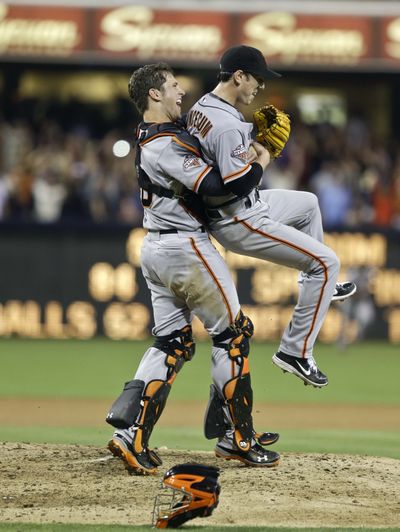 Giants catcher Buster Posey lifts Tim Lincecum after Saturday’s no-hitter against San Diego. (Associated Press)