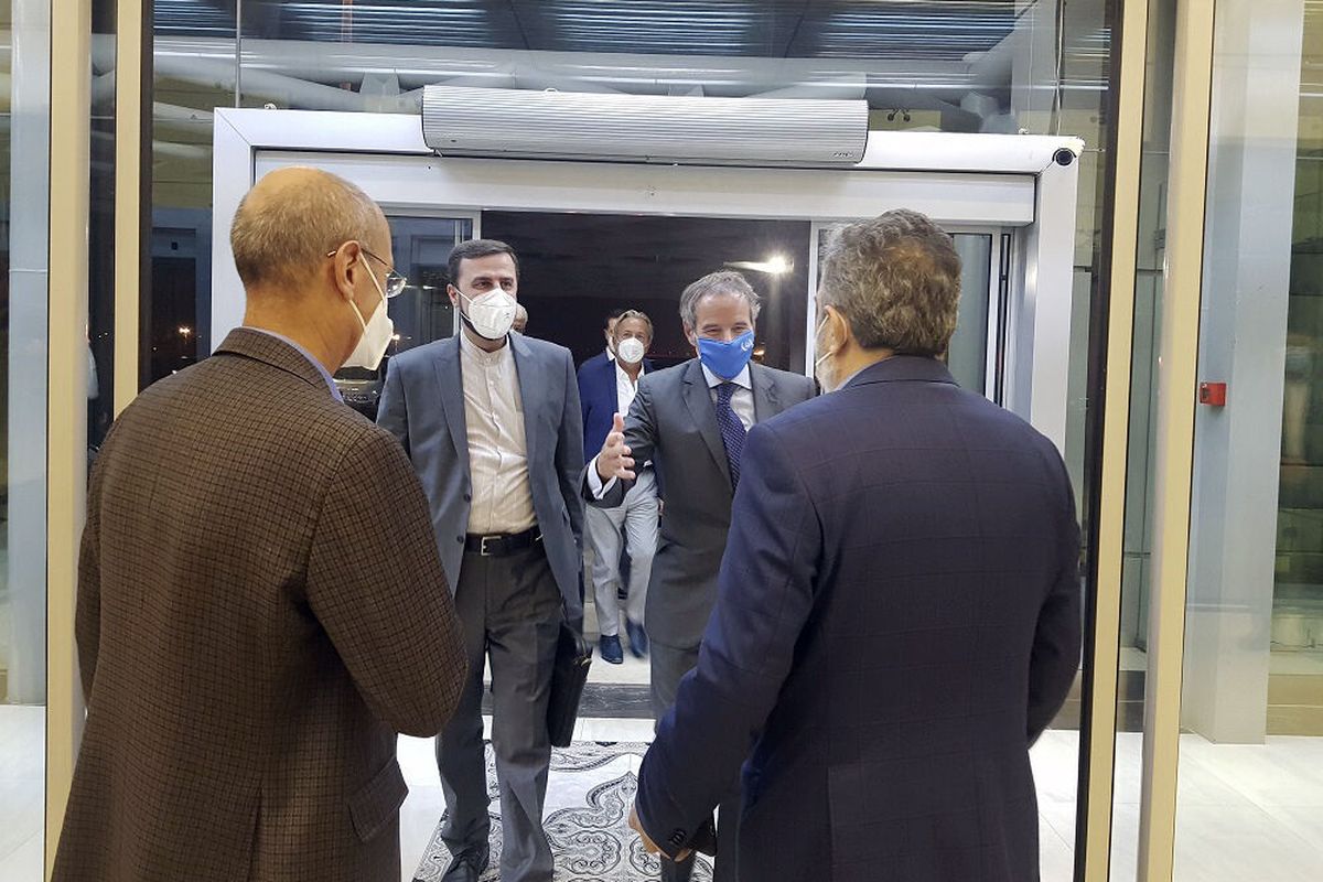 Director General of International Atomic Energy Agency, IAEA, Rafael Mariano Grossi, second right, is welcomed by Deputy Head of the Atomic Energy Organization of Iran, Behrouz Kamalvandi, right, as he is accompanied by Iran's envoy to the IAEA, Kazem Gharibabadi, second left, at Tehran Imam Khomeini International Airport, Iran, Saturday, Sept. 11, 2021.  (HOGP)
