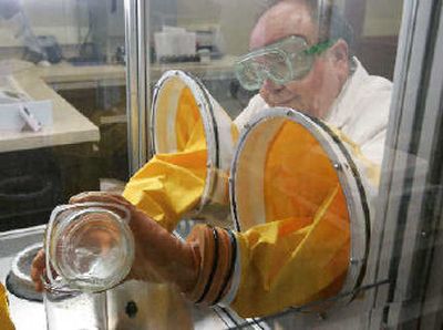 
Tom Marks, a compounding pharmacist, uses a sterile glove box to make a specialized mixture for a customer in Naperville, Ill. 
 (Associated Press / The Spokesman-Review)