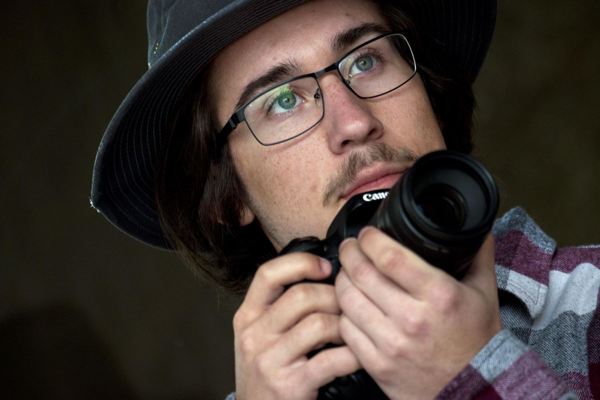 Post Falls High School senior Jacob Guy poses for a photograph at the school on Tuesday, March 27, 2018. He has his own photography business called That GUY Photography. (Kathy Plonka / The Spokesman-Review)