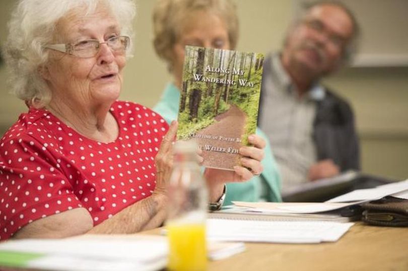 Jolene Feher holds up her self-published book of poetry after reading from it at the Poetry Scribes of Spokane on Sept. 2 at the North Spokane County Library. Like many others, Feher published her own work for posterity. (Jesse Tinsley / Spokesman-Review)