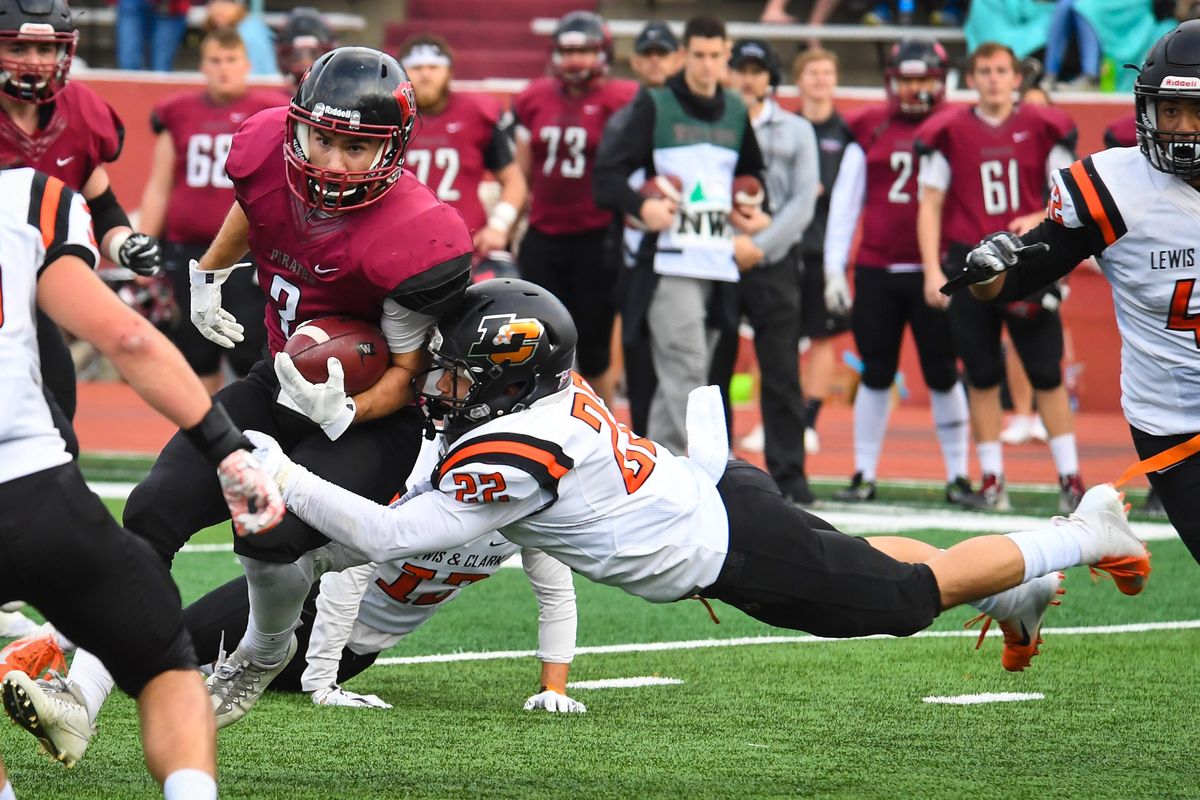 Whitworth WR Garrett McKay tries to run out of a flying tackle by Lewis & Clark DB Anakin Mares (22), Saturday, Nov. 3, 2018 in the Pine Bowl. (Dan Pelle / The Spokesman-Review)