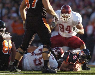 
WSU defensive linemen Mkristo Bruce (94) and Ropati Pitoitua combine for a sack on Oregon State quarterback Matt Moore. 
 (Christopher Anderson / The Spokesman-Review)