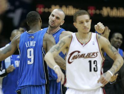 Orlando’s Rashard Lewis receives congratulations from Marcin Gortat after Wednesday’s win as the  Cavaliers’ Delonte West walks off the court.  (Associated Press / The Spokesman-Review)