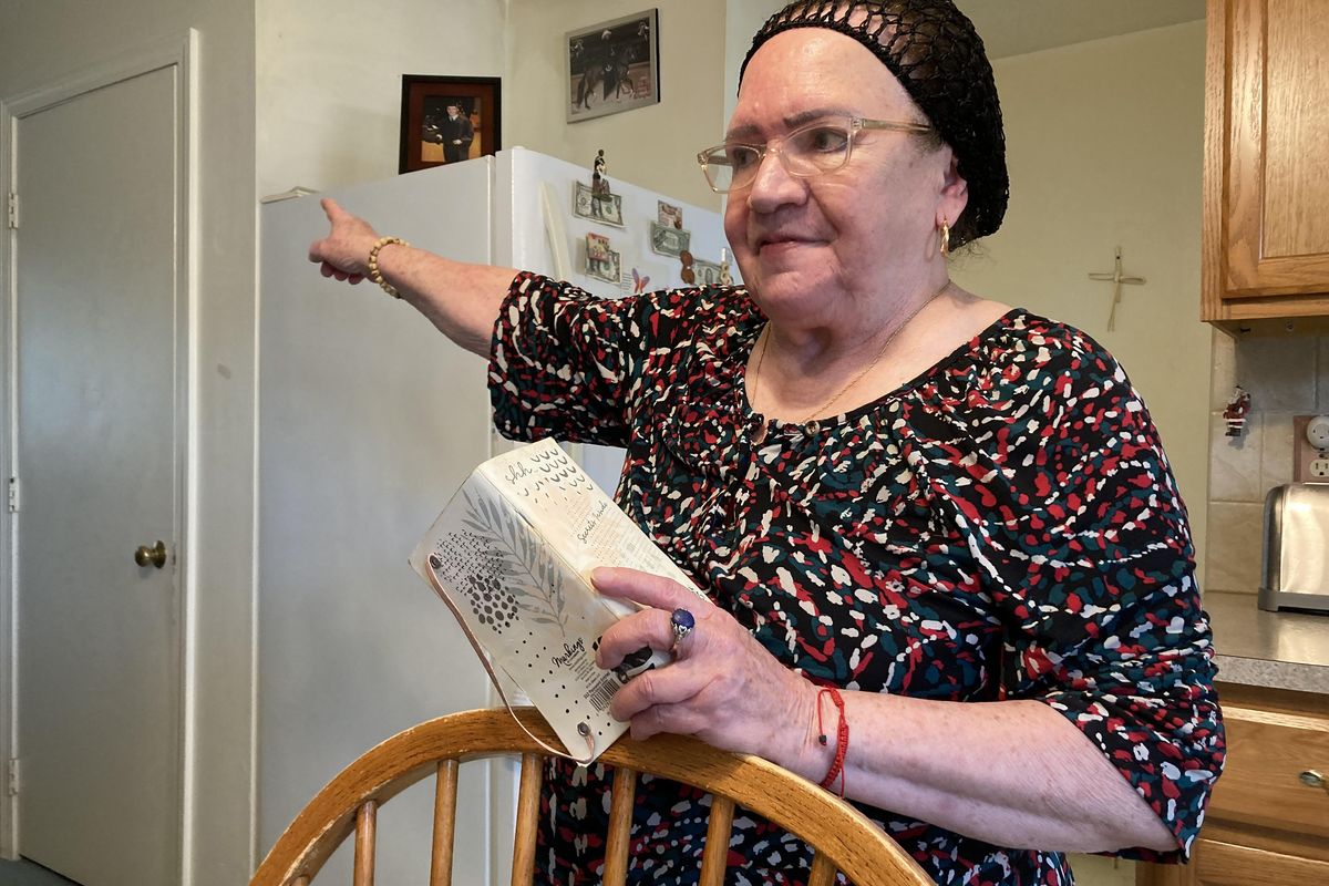 Piedad Fred, in her kitchen in Providence, Rhode Island, recounts a frustrating visit to a community health center after she injured her knee. (Lynn Arditi/KFF Health News/TNS)