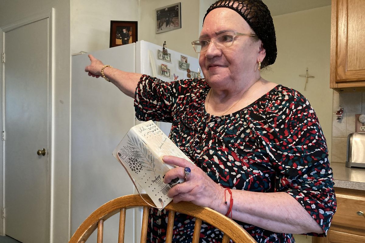 Piedad Fred, in her kitchen in Providence, Rhode Island, recounts a frustrating visit to a community health center after she injured her knee.    (Lynn Arditi/KFF Health News/TNS)