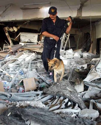 
An Egyptian police officer and his dog search for victims Friday in the debris of the Hilton hotel in Taba, Egypt, after an explosion Thursday night.An Egyptian police officer and his dog search for victims Friday in the debris of the Hilton hotel in Taba, Egypt, after an explosion Thursday night.
 (Associated PressAssociated Press / The Spokesman-Review)
