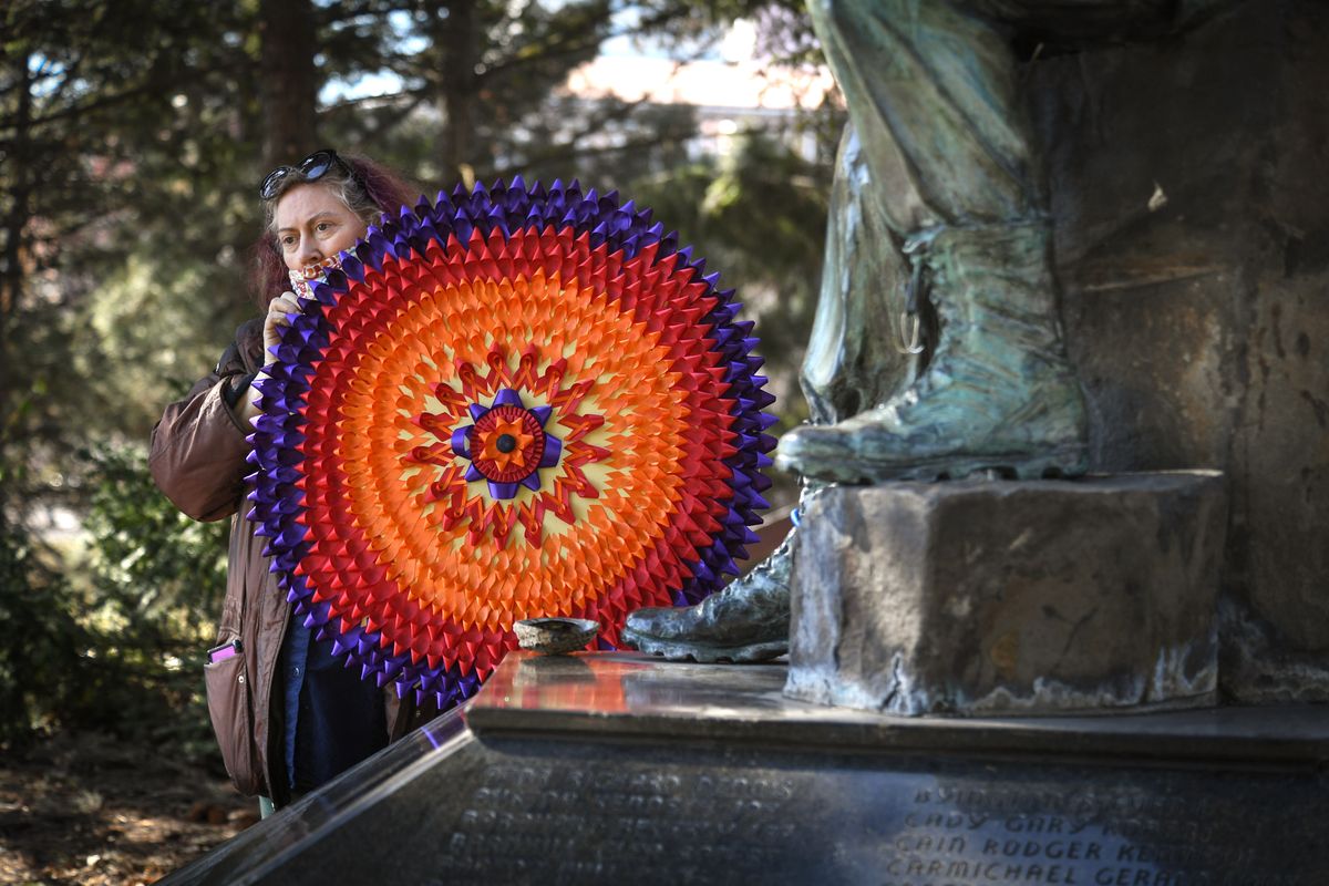 Valerie Waley created a ribbon wreath for the Spokane Veterans For Peace My Lai remembrance vigil at the Viet Nam statue in Riverfront Park on Tuesday, March 16, 2021.  (DAN PELLE/THE SPOKESMAN-REVIEW)