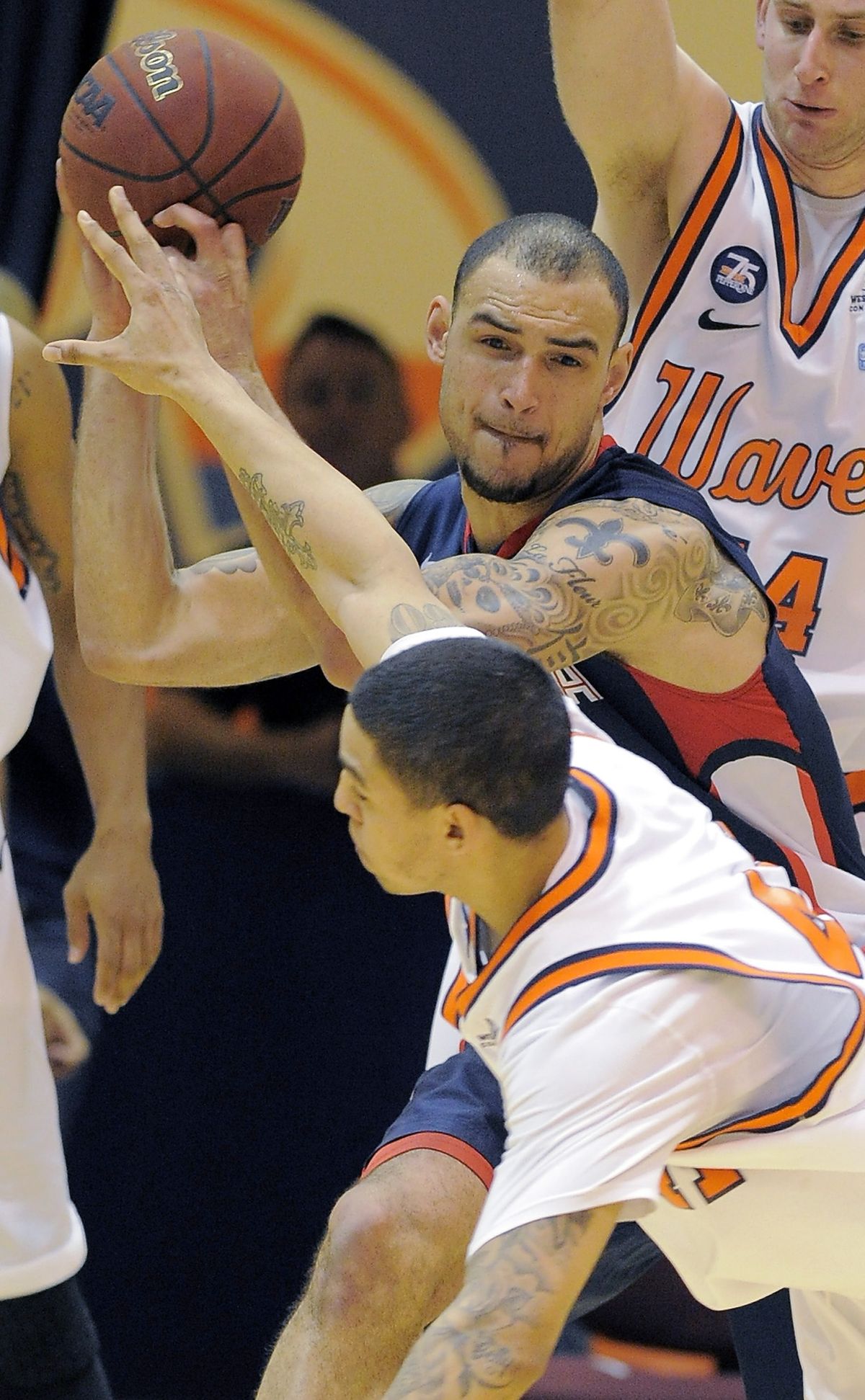 Gonzaga’s Robert Sacre shields the ball from Pepperdine Taylor Darby during Saturday’s game. (Associated Press)