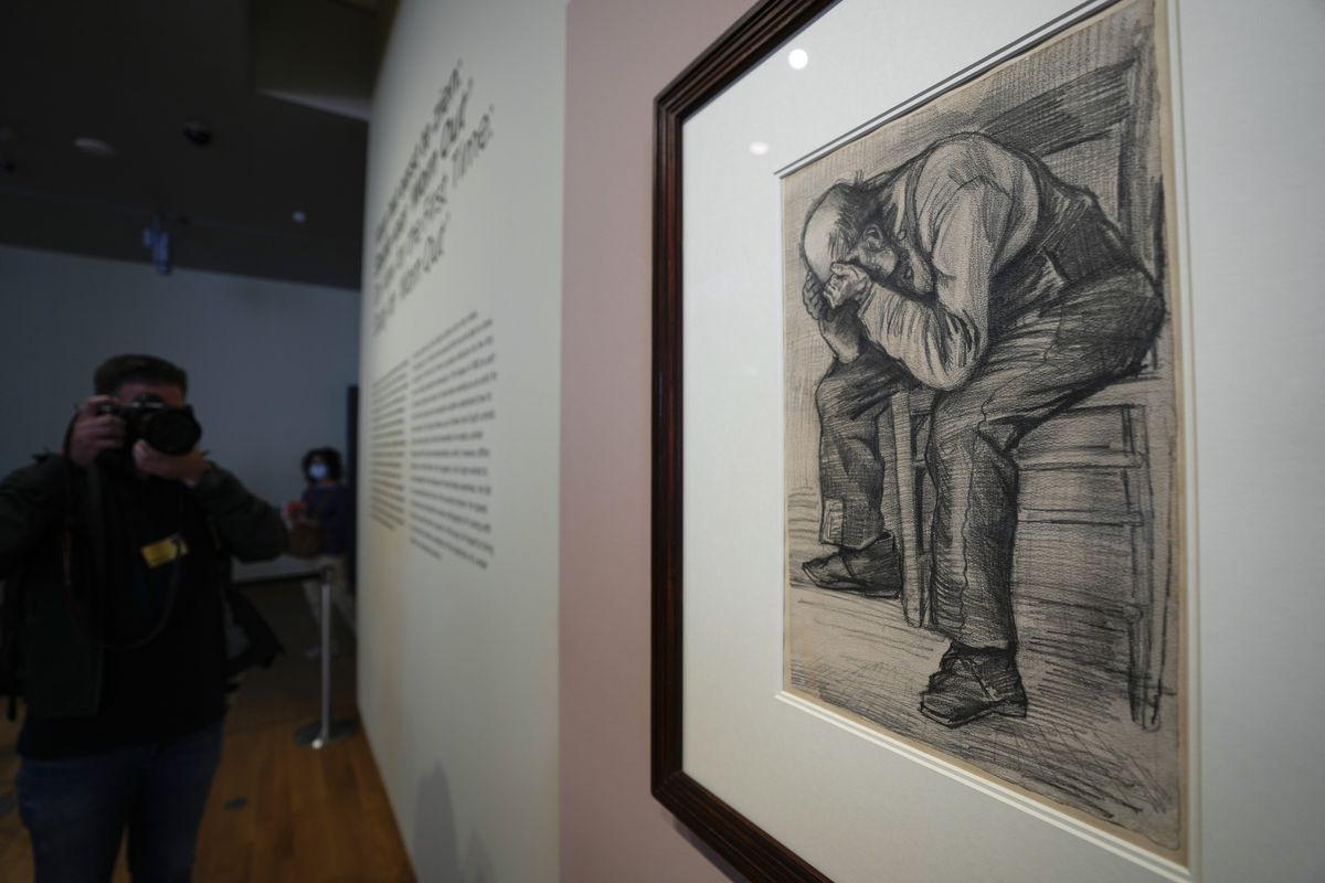 A photographer takes pictures of Study for "Worn Out", a drawing by Dutch master Vincent van Gogh, dated Nov. 1882, on public display for the first time at the Van Gogh Museum in Amsterdam, Netherlands, Thursday, Sept. 16, 2021.  (Peter Dejong)