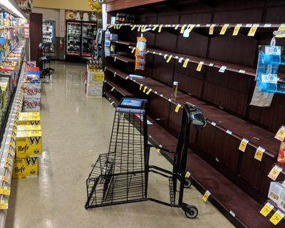 Supermarket shelves are stripped bare of bottled water in Salem, Ore., late Tuesday May 29, 2018, after officials warned residents that tap water was unsafe for children and the elderly due to an algae bloom. (Tom James / Associated Press)