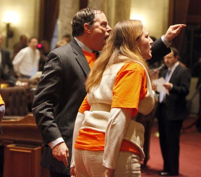 State Reps. Jon Richards, D-Milwaukee, left, and Kelda Helen Roys, D-Madison, shout after Republicans cut off debate and voted on the budget repair bill at the state Capitol in Madison, Wis., early Friday. (Associated Press)