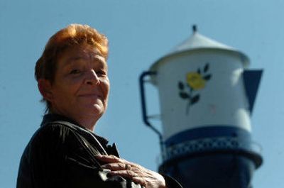 
Dolli Massender stands in front of the Spirit Lake water tower last week. She donated the funds to  add  a handle and spout and give it a paint job. 
 (Jesse Tinsley / The Spokesman-Review)