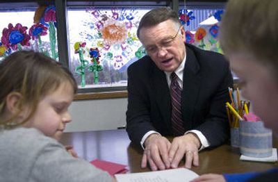 
Riverside School District Superintendent Galen Hansen reads  with second-graders Breanan Sellers, left, and Jeffrey Thompson at Chattaroy Elementary School. 
 (Holly Pickett / The Spokesman-Review)