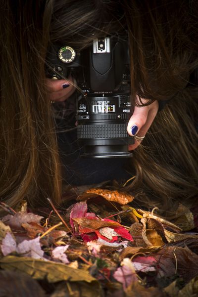 Focused on learning: Ferris photography student Mariah Brown, 15, takes a macro shot of dew on leaves at Spokane Falls Community College on Monday. About 100 high school photography students from Spokane Public Schools were attending the Fall Arts Festival, learning about capturing moments in their photography. (Colin Mulvany)