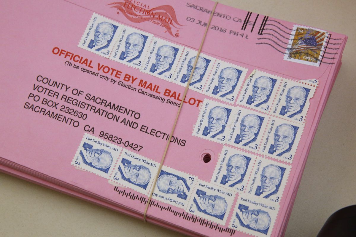 FILE - This Friday, June 10, 2016 file photo shows a mail-in ballot yet to be counted at the Sacramento County Registrar of Voters office, in Sacramento, Calif. Over 100,000 mail-in ballots were rejected by election officials in California