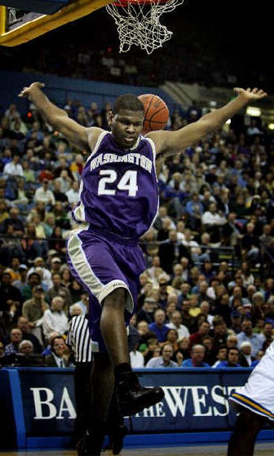 
Washington forward Jamaal Williams follows through on a first-half dunk. 
 (Associated Press / The Spokesman-Review)