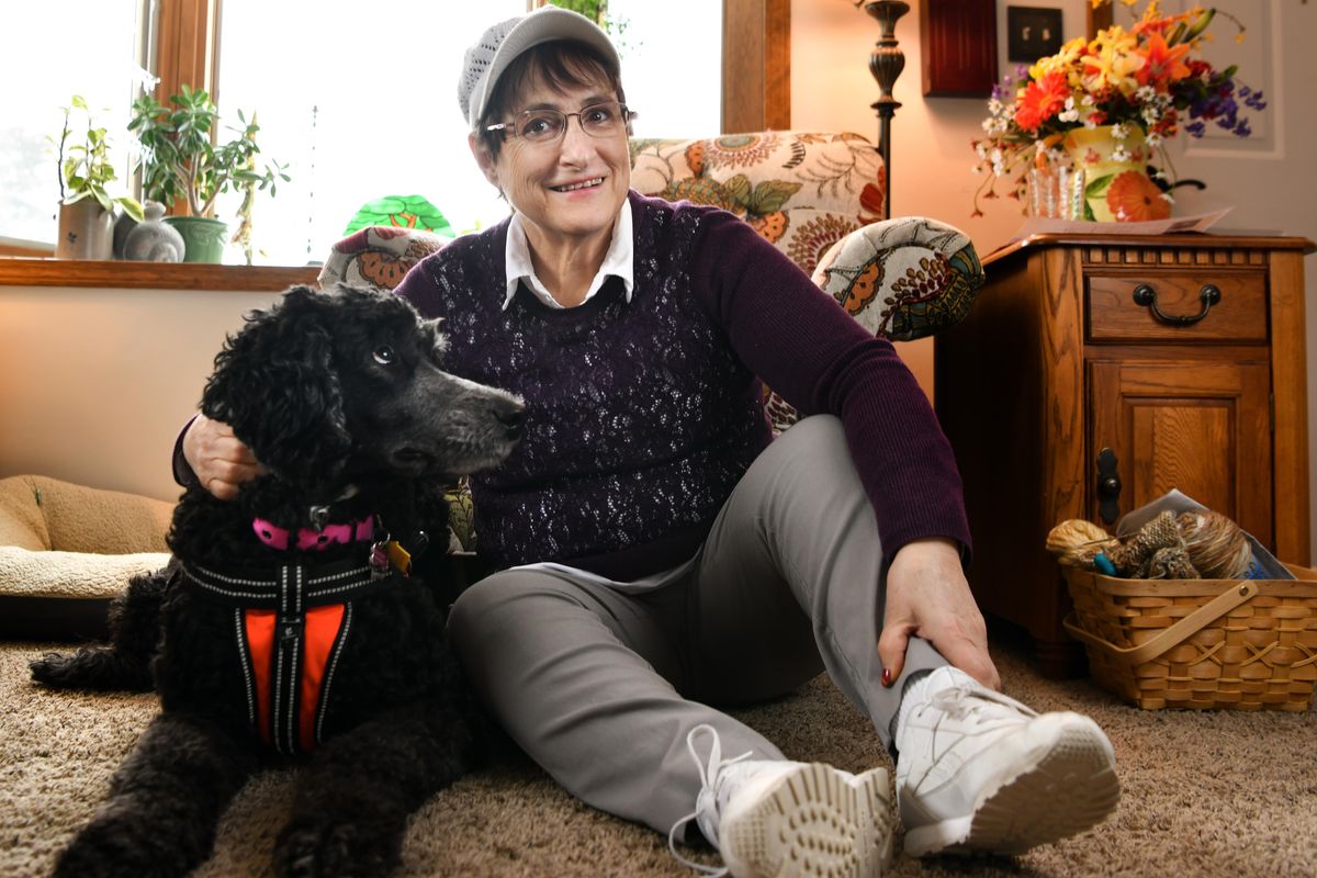 Marcia Lathrop poses for a photo with her service dog Teagan on Monday, Feb. 25, 2019, at her home in Spokane, Wash. (Tyler Tjomsland / The Spokesman-Review)