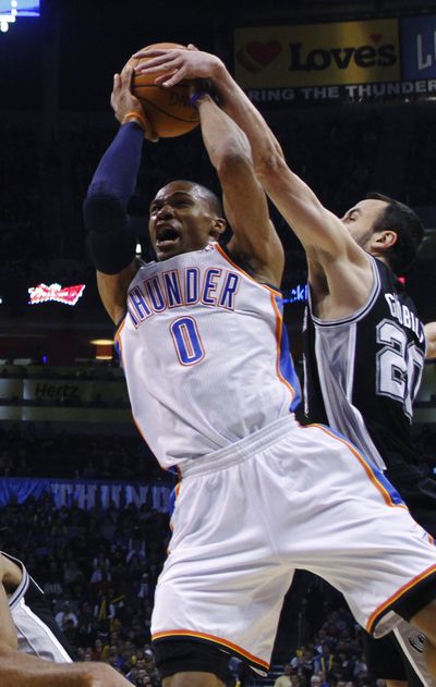 San Antonio Spurs guard Manu Ginobili, right, reaches in to block a shot by Oklahoma City Thunder guard Russell Westbrook.  (Associated Press)