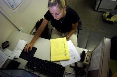
Michelle Morris enters records  Thursday into Spokane's 211 database,  a telephone health and social service resource being prepared. 
 (Jed Conklin / The Spokesman-Review)